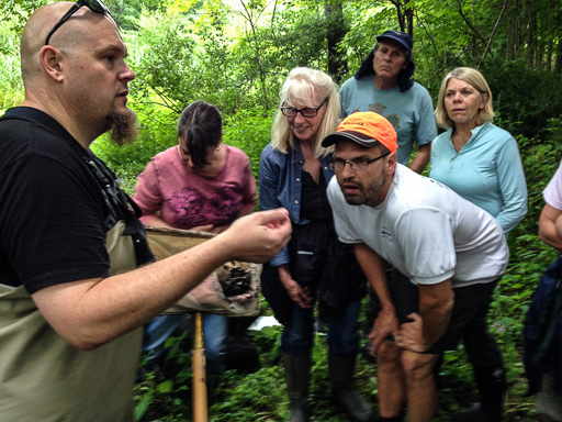 Photo of volunteers learning to identify species found in tributaries to the Great Swamp